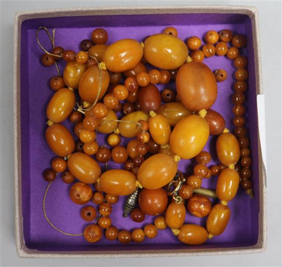 Two amber bead necklaces and a quantity of loose amber bead, gross 63 grams.